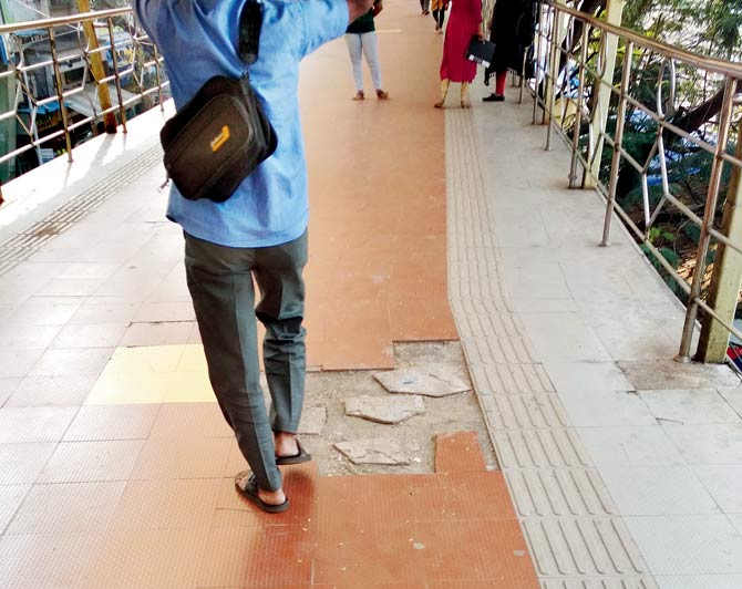 Pedestrians say broken tiles with their jagged edges pose a risk