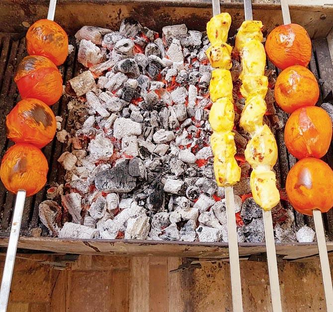 The items are prepared on a coal-fired barbecue at the Baba residence