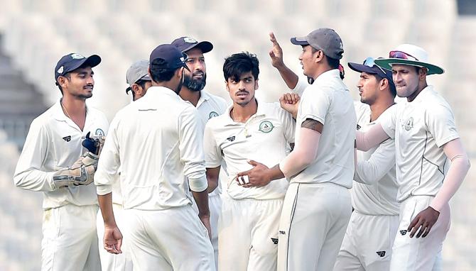 Vidarbha’s Rajneesh Gurbani (centre) celebrates after claiming the wicket of Karnataka
