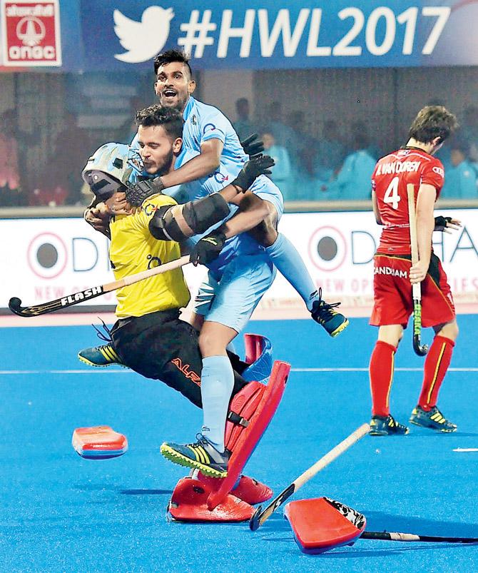 Jubilant Indian players celebrate with goalkeeper Akash Chikte (yellow jersey) after their win over Belgium in the penalty shoot-out during the Hockey World League quarters tie in Bhubaneswar yesterday. pic/PTI