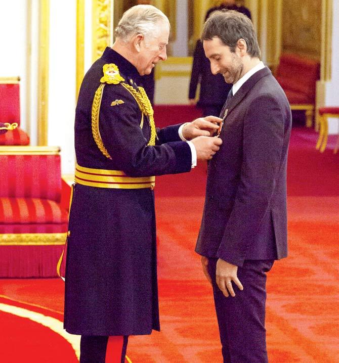 Idris Khan receives the OBE from the Prince of Wales at Buckingham Palace