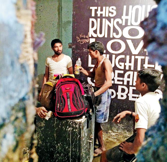 Labourers take a break during work on the ground floor of Mamta building in Bandra West. Pics/Sameer Markande