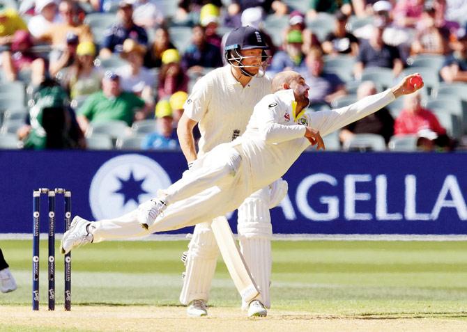 Australia offie Nathan Lyon dives to take a catch to dismiss England