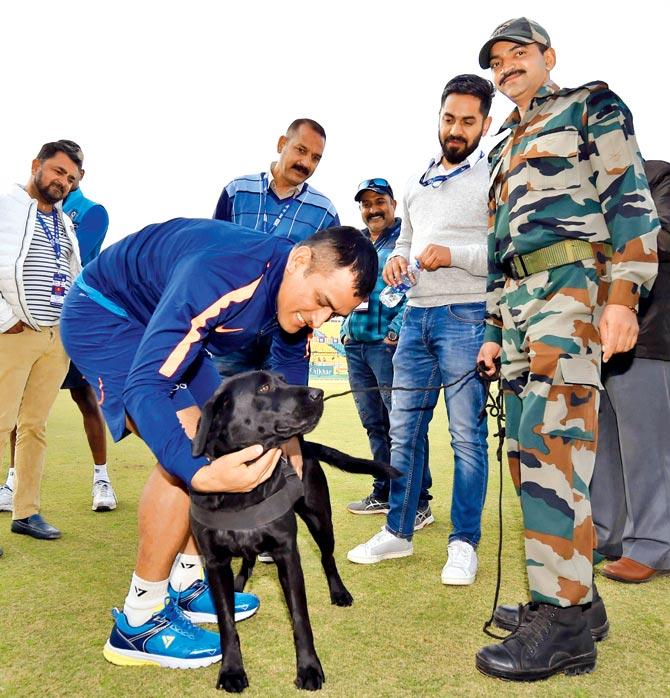 Mahendra Singh Dhoni with a sniffer dog. Pic/PTI