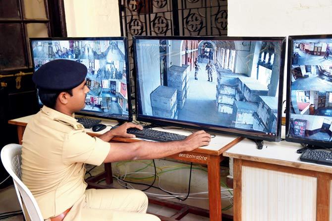 A policeman monitors CCTV election footage at a centre in Ahmedabad. Pic/AFP