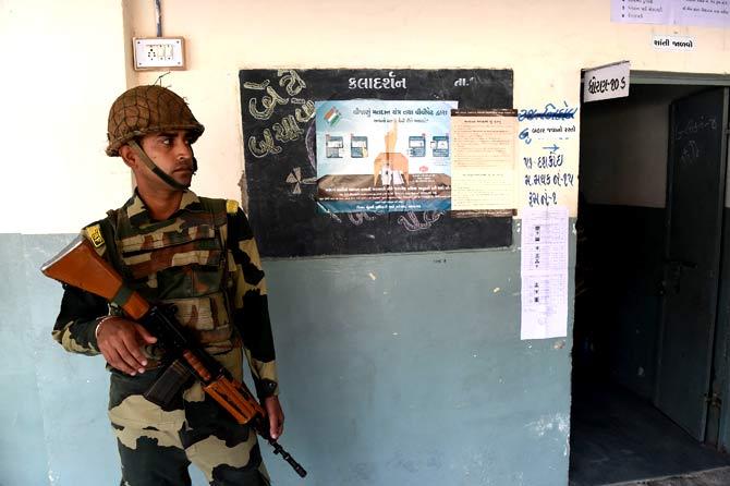 An Indian para-military soldier keeps vigil at a re-polling centre at Nava Naroda on the outskirts of Ahmedabad. Pic/AFP