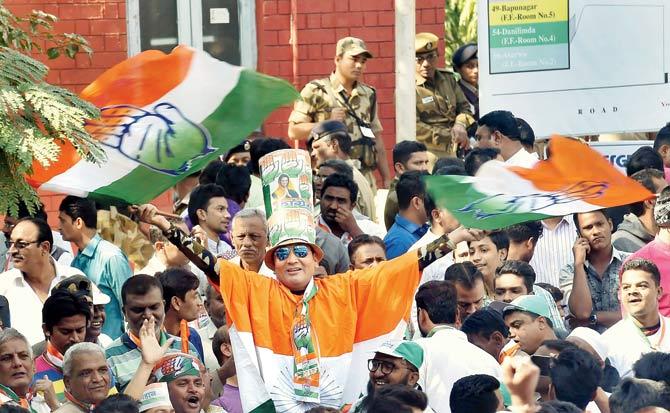 Congress party supporters celebrate outside the Gujarat College counting centre in Ahmedabad