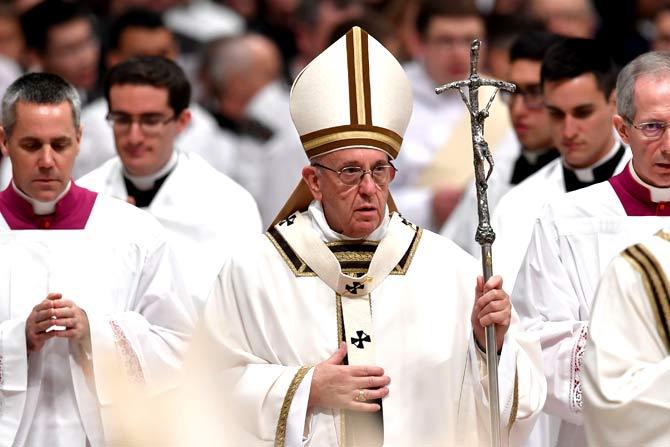 Pope Francis looks on at the end of mass on Christmas eve marking the birth of Jesus Christ at St Peter