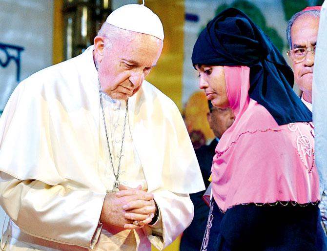 Pope Francis meets with a Rohingya refugee. Pic/AFP