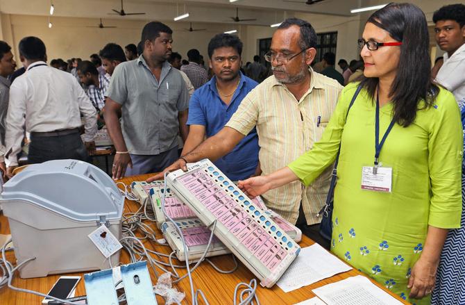 Election observers inspecting the EVM (Electronic Voting Machines) at a distribution centre, ahead of bypolls for the Dr Radhakrishnan Nagar constituency, in Chennai on Friday. Pic/PTI 
