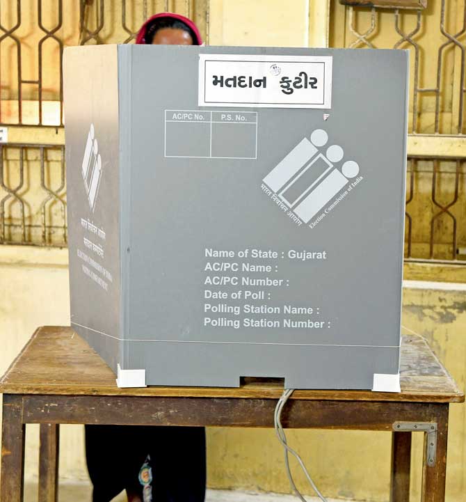 A voter casts her ballot during the first phase of the much anticipated Vidhan Sabha Gujarat elections at Limbdi, which is approximately 100 km from Ahmedabad