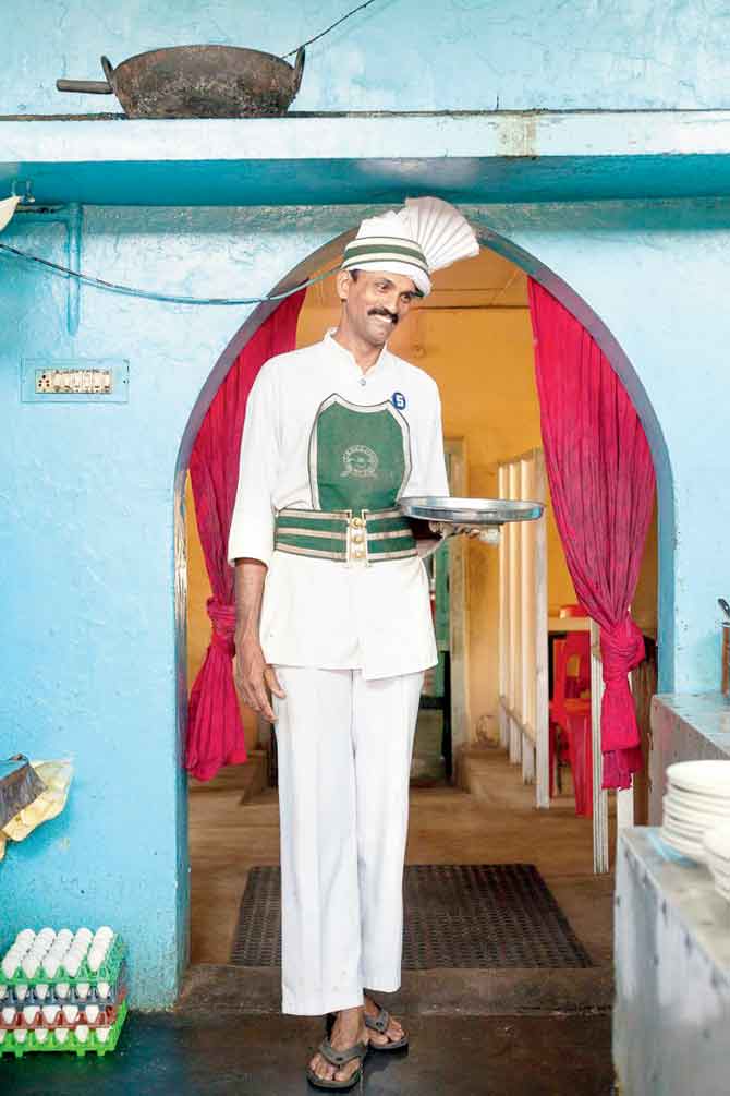 Sangaran, a waiter who worked at the now-shuttered Indian Coffee House in Kollam, Kerala, for 17 years 