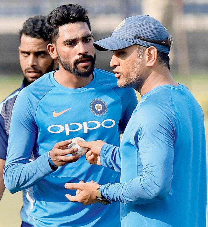 Uncapped paceman Mohammed Siraj discusses a point with India veteran Mahendra Singh Dhoni in Cuttack yesterday. Pic/PTI