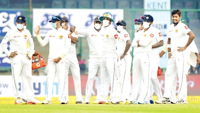 Sri Lankan players wear anti-pollution masks during the third Test against India at Feroz Shah Kotla in New Delhi on Tuesday. Pic/PTI