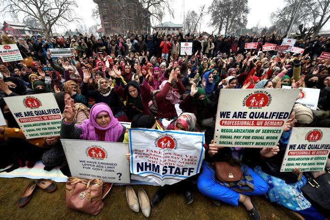 Contract employees of National Health Mission shouting slogans during a protest in favor of their demands, in Srinagar. Pic/AFP
