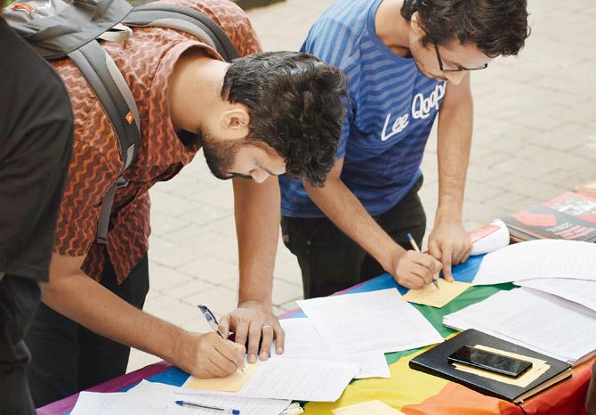 College students seen signing postcards. Pic/Abhisikta Dasgupta