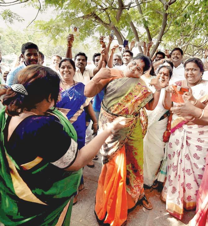 His supporters celebrate after he established a decisive lead. Pics/PTI