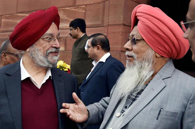 Minister of State for Housing & Urban Affairs Hardeep Singh Puri with MP Harinder Singh Khalsa during the winter session at Parliament House in New Delhi on Tuesday. Pic/PTI Photo 