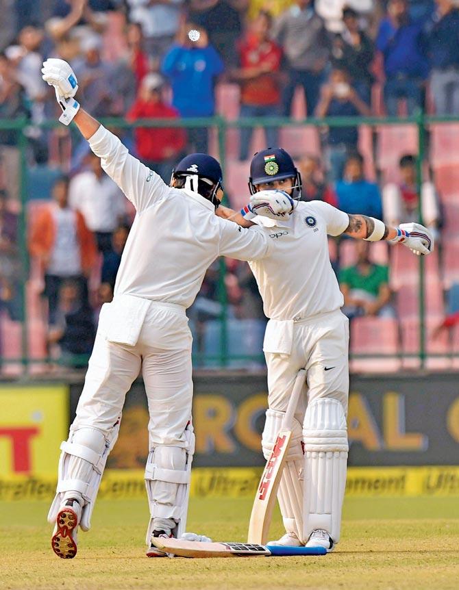 Murali Vijay (left) celebrates with India skipper Virat Kohli after completing his century against Sri Lanka on Day One of the third Test  at the Ferozshah Kotla in New Delhi on Saturday. Pic/PTI 