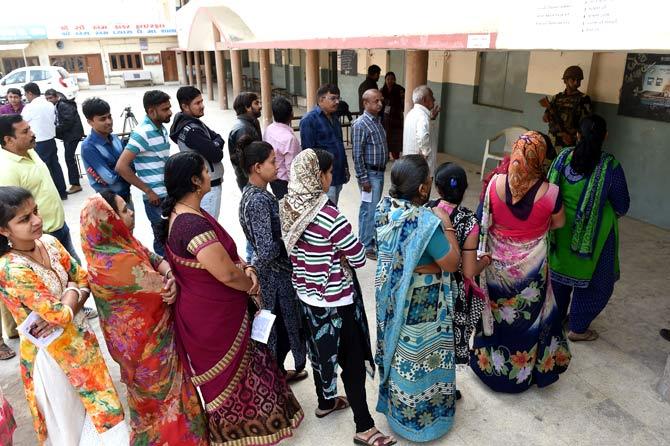 Indian voters wait for their turn to cast their votes in a re-polling centre at Nava Naroda on the outskirts of Ahmedabad. Pic/AFP