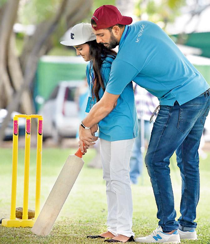 Veteran India cricketer Yuvraj Singh corrects a girls batting stance during a UNICEF sports initiative in Colombo on Monday. Pic/AFP