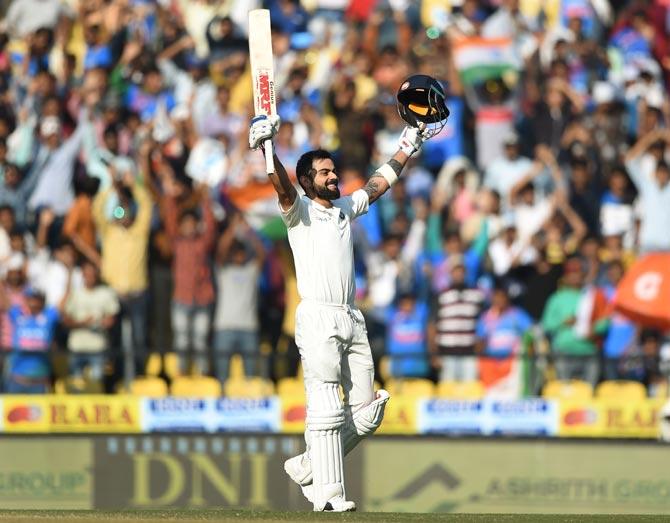 This file photo taken on November 26, 2017 shows Indian cricket team captain Virat Kohli celebrating after scoring a double century (200 runs) on the third day of the second Test cricket match between India and Sri Lanka at the Vidarbha Cricket Association Stadium in Nagpur. National team skipper Virat Kohli has demanded a greater share of India