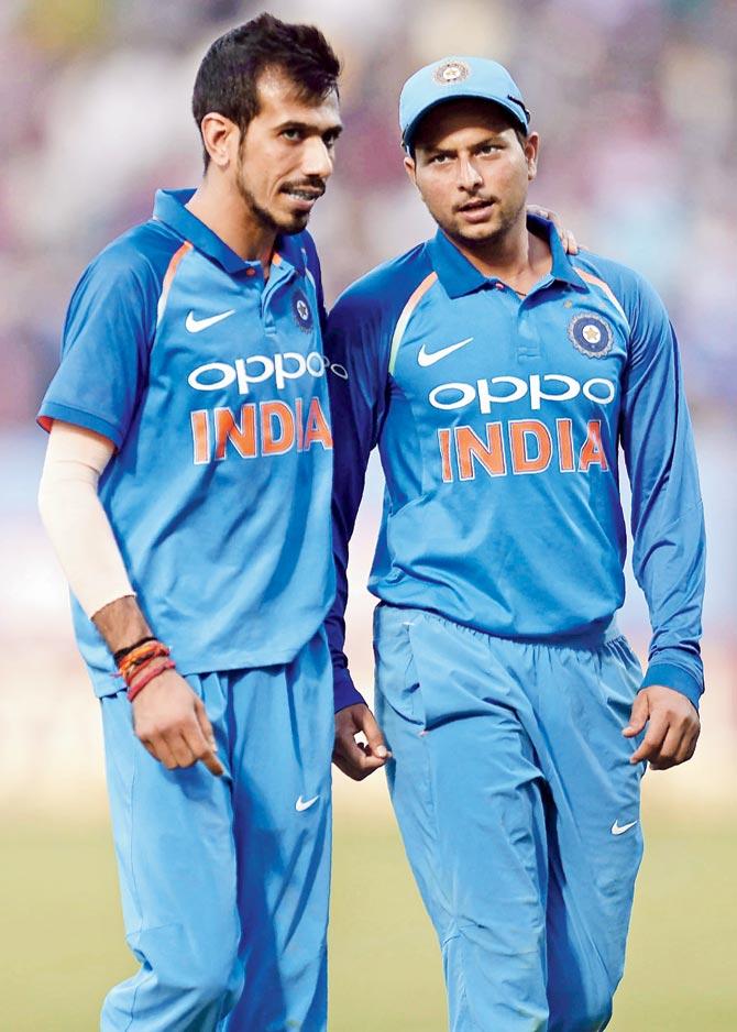 Indian spinners Yuzvendra Chahal (left) and Kuldeep Yadav walk back to the pavilion during the third one-day international against SL in Visakhapatnam yesterday before India