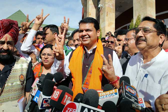 Maharashtra Chief Minister Devendra Fadnavis along with the party MLAs flashes victory sign as they celebrate BJP