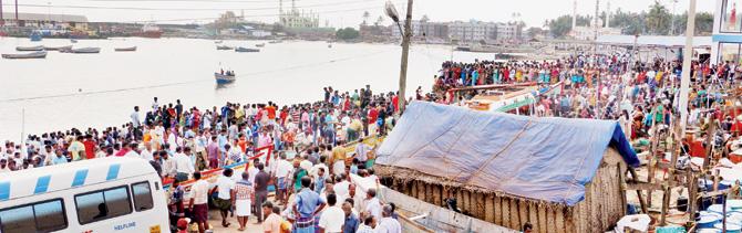 Families of fishermen wait for those who are yet to return home at Vizhinjam harbour, in Thiruvananthapuram, on Saturday. Pic/PTI