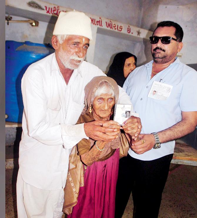 126-year-old Ajiben arrives to cast her vote in Rajkot. pics/pti