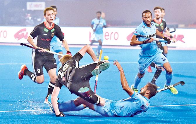 India forward Gurjant Singh (second from right) takes a tumble after colliding with a German defender during a Hockey World League Final encounter at the Kalinga Stadium in Bhubaneswar yesterday. India lost 0-2 and remain winless at the end of the league stage. Pic/PTI