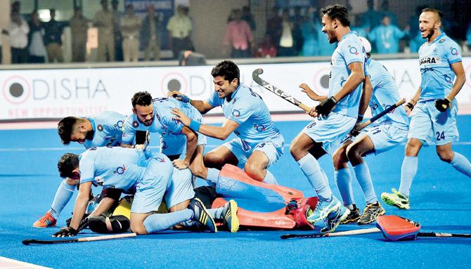 Indian players celebrate their win over Belgium with a grounded Akash Chikte in Bhubaneswar. PIC/PTI