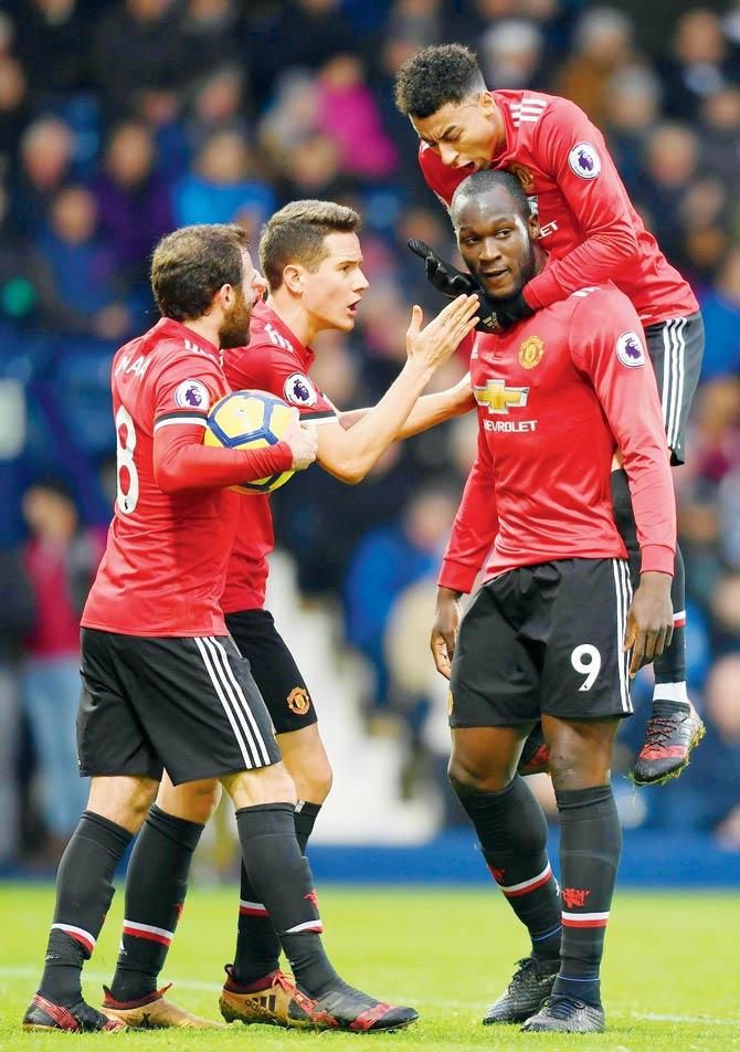 Lukaku (second from right) is surrounded by teammates after scoring United