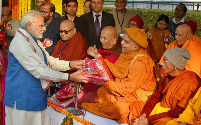 Prime Minister Narendra Modi presents gifts to Buddhist monks at a ceremony to pay homage to Babasaheb Dr. B.R. Ambedkar