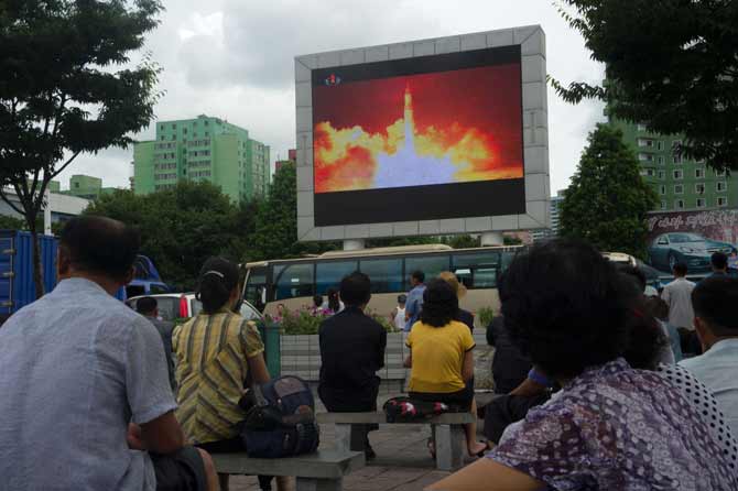 This file photo taken on July 29, 2017 shows people watching as coverage of an ICBM missile test is displayed on a screen in a public square in Pyongyang. North Korea slammed fresh UN sanctions imposed over its missile tests as an "act of war" on December 24, 2017, its first response to the latest diplomatic move to punish Pyongyangs ever-accelerating weapons drive. Pic/ AFP