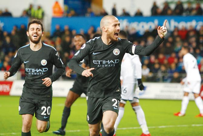 Manchester City captain David Silva (right) celebrates after scoring against Swansea City in an EPL match on Wednesday. pic/AFP