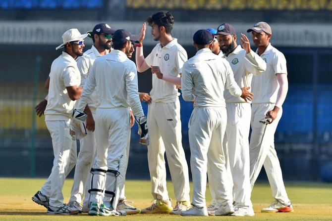 Vidarbha bowler Aditya Thakare celebrates with his teammates after dismissing Delhi batsman K Chandela during the Ranji Trophy final cricket match between Delhi and Vidarbha, in Indore. Pic/ PTI