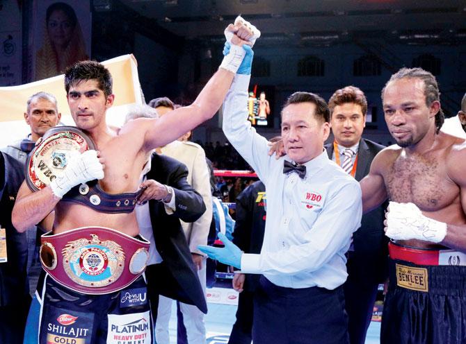 Indian boxer Vijender Singh (left) is declared the winner after his pro bout against Ernest Amuzu in Jaipur on Saturday