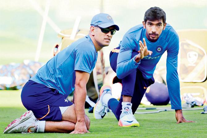 MS Dhoni and Jasprit Bumrah during a practice session ahead of the third T20 International against England in Bangalore yesterday. Pic/PTI
