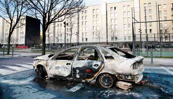 A picture taken on February 7 shows the wreckage of a burnt car in suburban Paris, owing to the violence. Pic/AFP