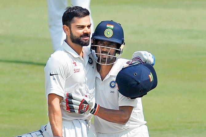 Wriddhiman Saha congratulates India captain Virat Kohli on reaching his double century on Day Two of the one-off Test against Bangladesh at the Rajiv Gandhi International Cricket Stadium in Uppal, Hyderabad yesterday. Pic/AFP 