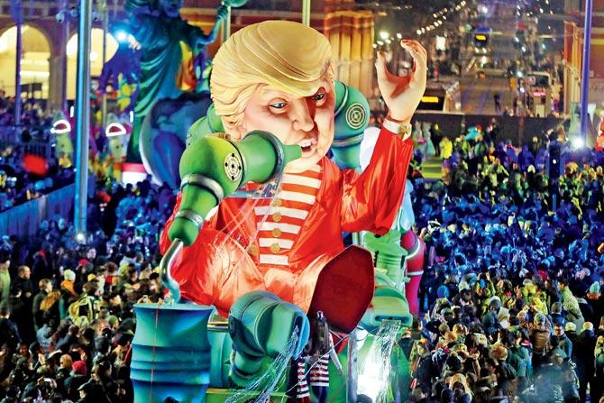 People look at the float ‘Wind of Change’ depicting US President Donald Trump as it parades in the streets of southeastern France. Pic/AFP