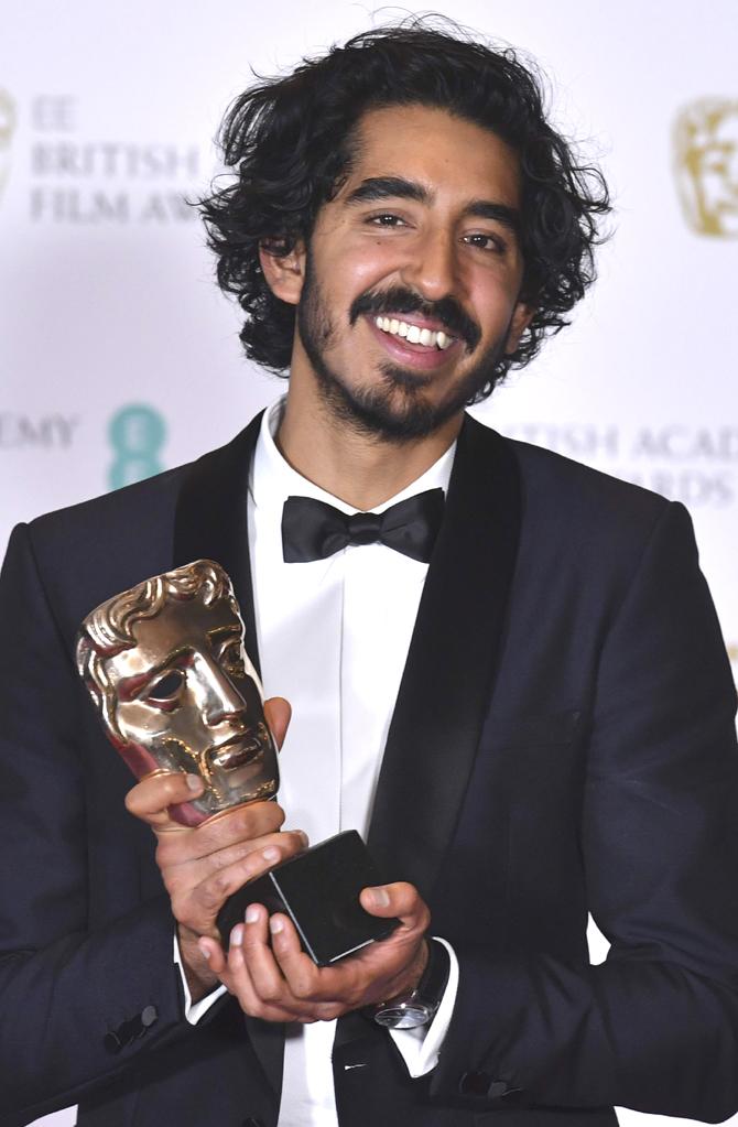 British actor Dev Patel poses with the award for a Supporting Actor for his work on the film 