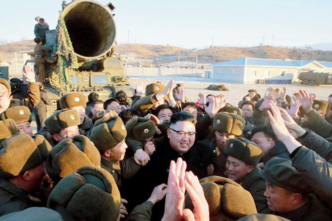 Kim Jong-Un surrounded by soldiers as he inspects the test-launch of the ballistic missile. Pics/AFP
