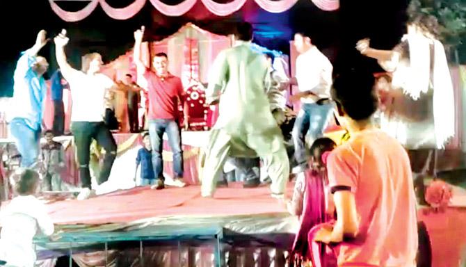 Sub-inspector Avinash Palde (in red tshirt) dances on stage with Amjad Irani (in green kurta), who was earlier arrested in a MCOCA case, and others