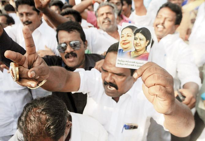 Members of AIADMK celebrate in front of the Assembly after trust vote win for Palanisamy. Pic/AFP
