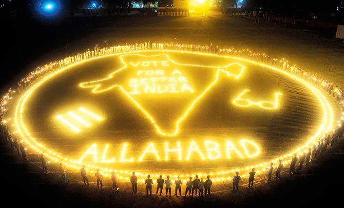 Candles are lit in a giant mural in a stadium during a voting awareness campaign organised by the Allahabad District administration. Pic/AFP