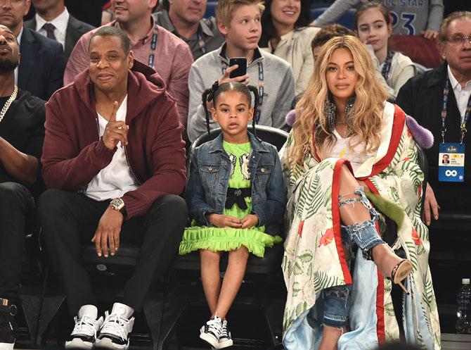 Jay Z, Blue Ivy Carter and Beyonce Knowles attend the 66th NBA All-Star Game at Smoothie King Center on February 19, 2017 in New Orleans, Louisiana. Images/AFP