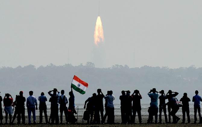 People watch the launch of the PSLV at Sriharikota
