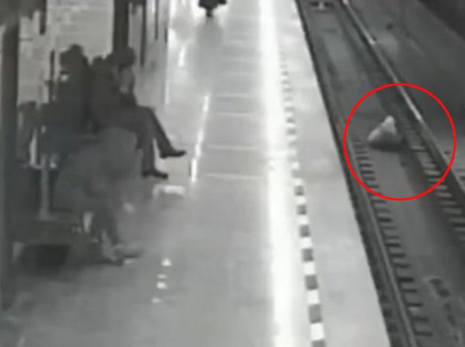 Caught on camera: Man jumps on train tracks to save boy